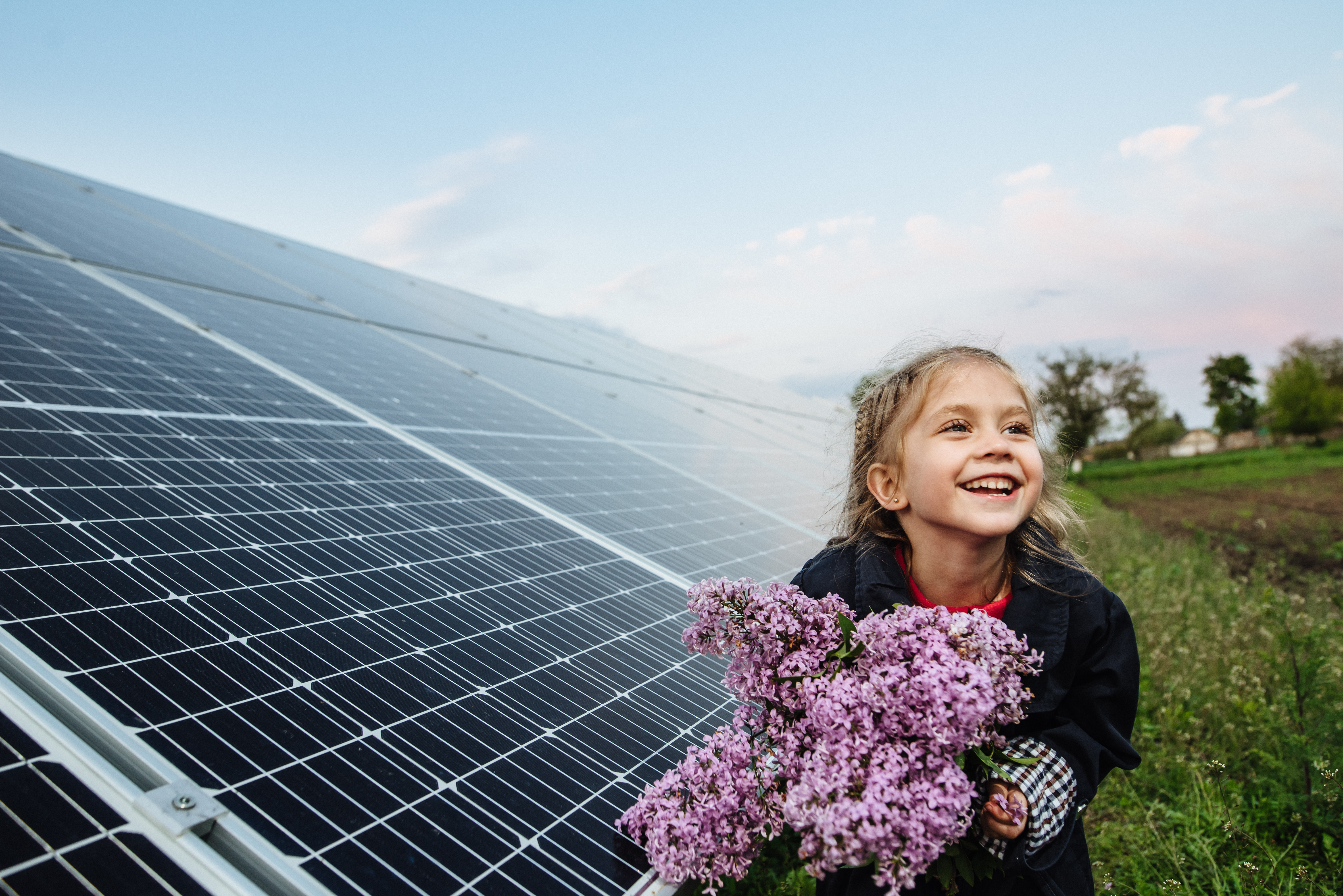 https://www.flogas.ie/assets/uploads/images/Affinity/girl_with_flowers_at_solar_panel.png