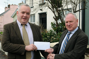 (from left) Michael Keogh of Flogas Ireland presenting a €500 cheque to Dr John Griffin, president of the SVP Ballyhaunis Conference, on Tues 26 November in Ballyhaunis.