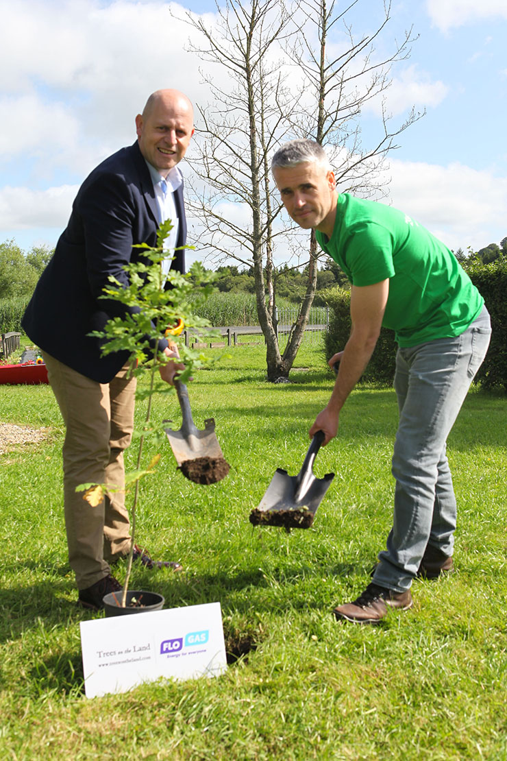 Photo showing Flogas and Trees on the Land representatives planting an oak tree sponsored by Flogas